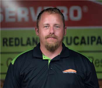 a guy in front of a green SERVPRO background
