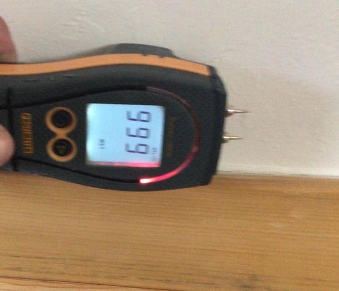 Moisture meter reading moisture content in home.