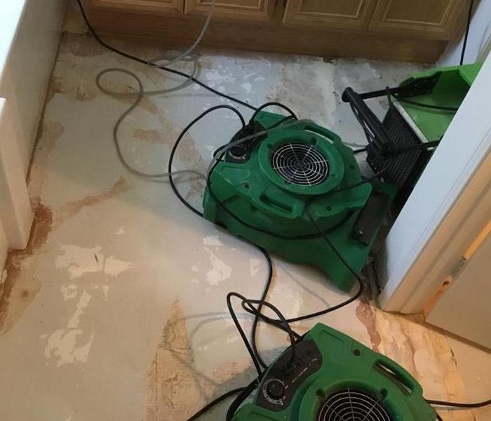 air movers on the ground of a ripped up floor