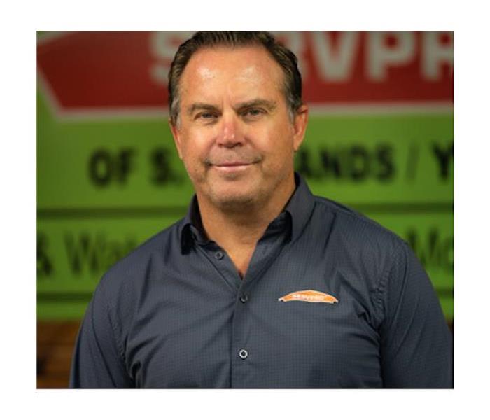 Owner, Jeffrey Padgett, posing for a photo in SERVPRO shirt.