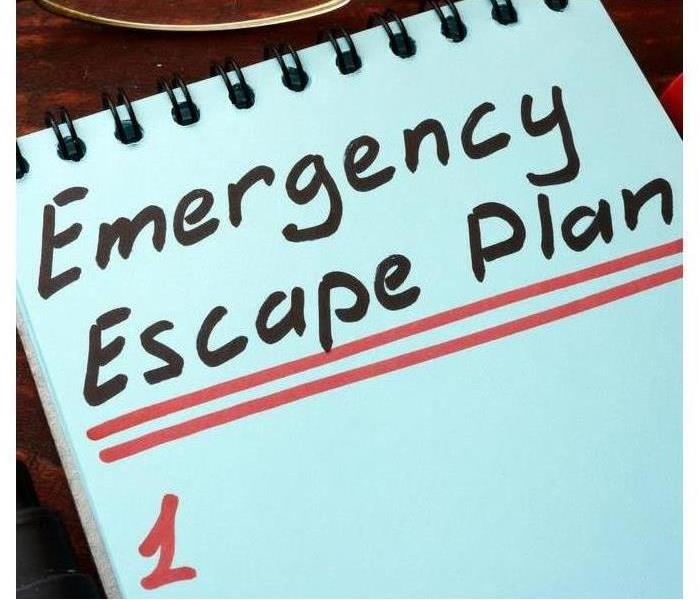 Emergency Escape Plan written on a notepad with marker.