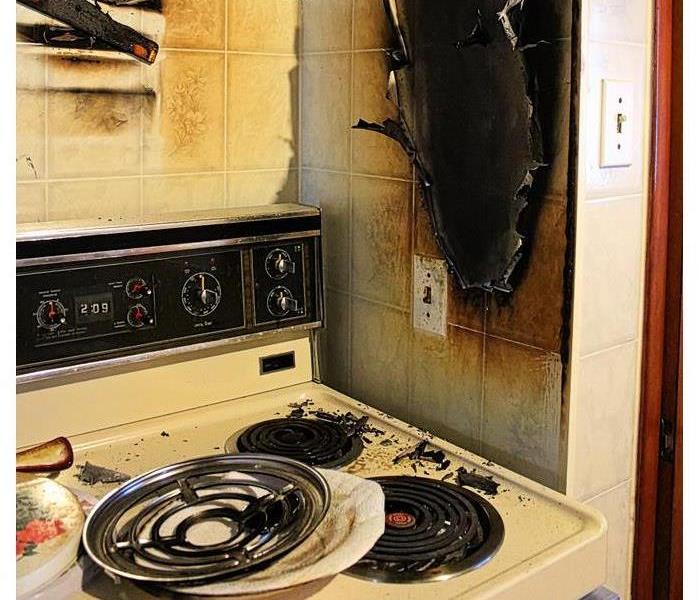 a charred kitchen wall near the stove